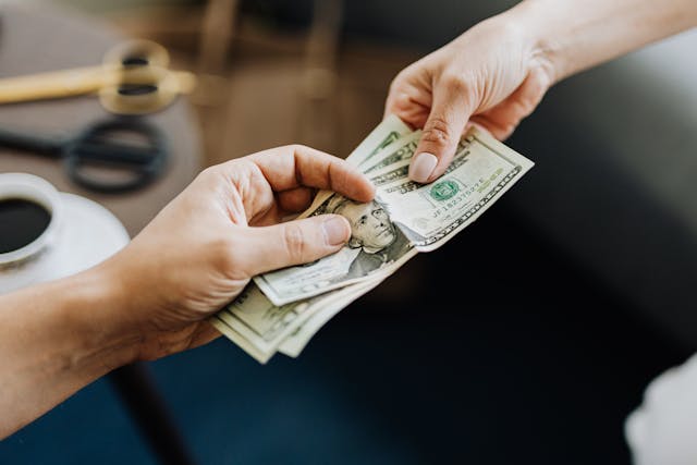 two hands exchanging money