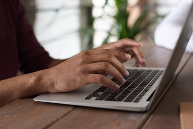 person typing on laptop